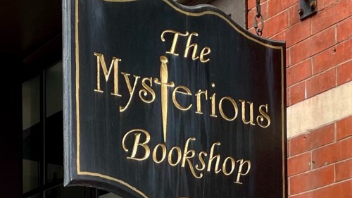 Exterior sign for The Mysterious Bookshop in NYC.