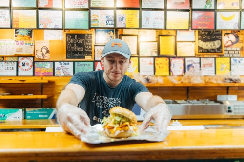 Man serving a bagel at a counter