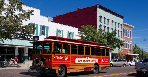 Red trolley on a brick street
