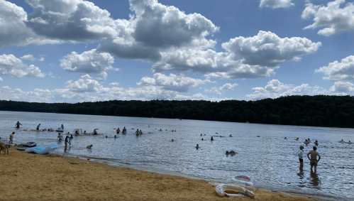 People swimming on a cloudy day at Yellowstone Lake State Park beach