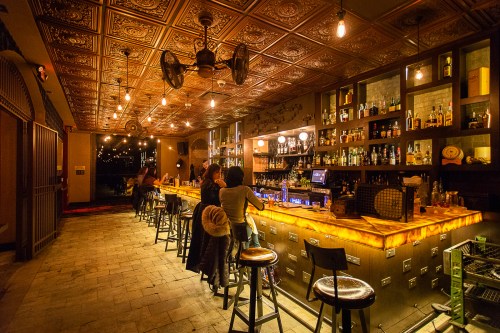 Dimly lit bar with tin ceiling