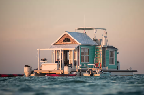 Exterior view of the Key West Outpost floating houseboat with front deck and water views