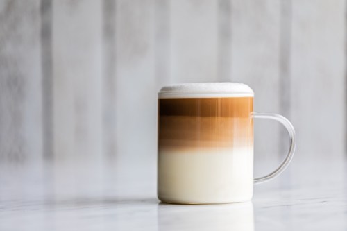 A layered latte in a clear mug.