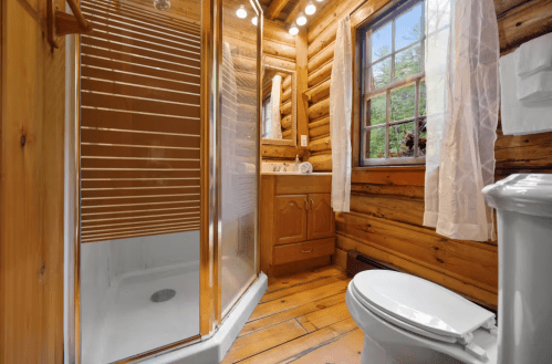 Rustic wood bathroom in log cabin in Maine