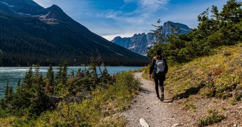 Female Hiker and Lake Josephine on The Grinnell Glacier Trail, Glacier National Park, Montana, USA