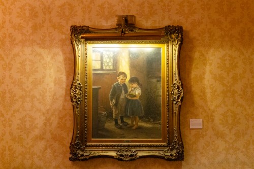 Painting of two children in an ornate frame