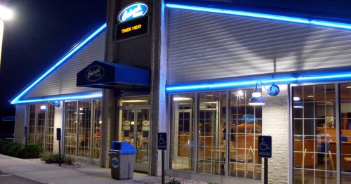 Lighted facade of world's largest Culver's restaurant at night in Edgerton, Wisconsin.