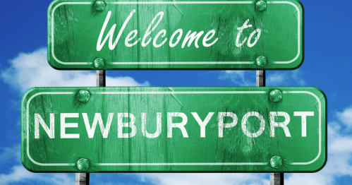A green sign is set against a blue sky in Newburyport, Massachusetts reading "Welcome to Newburyport"