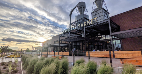 The Sawmill market, a fixture of the ABQ dining scene shines bright under a sunset light.