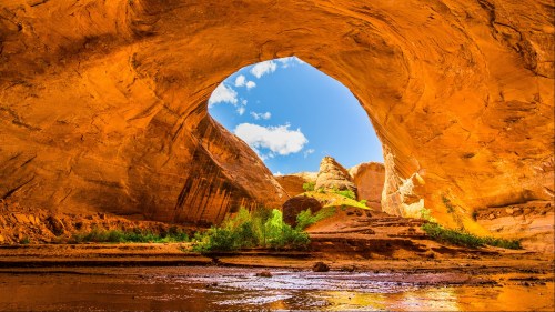 View from inside the red arches of Coyote Gulch in Utah's Glen Canyon National Recreation Area.