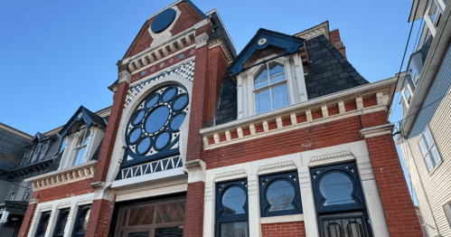 Exterior of a large brick castle-like building in RI with ornate windows
