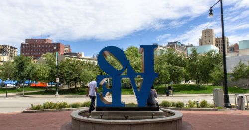 A blue sculpture that says “Love.”