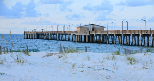 The fishing pier and sand of the beach at Gulf Shores