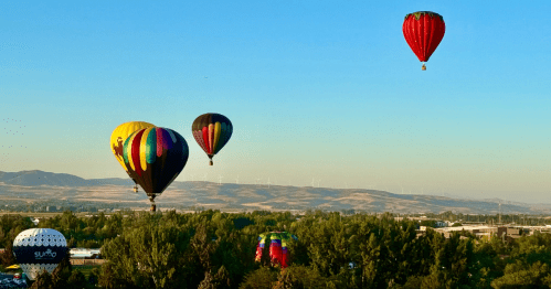 Colorful air balloons fill an early morning sky above Ammon, Idaho.