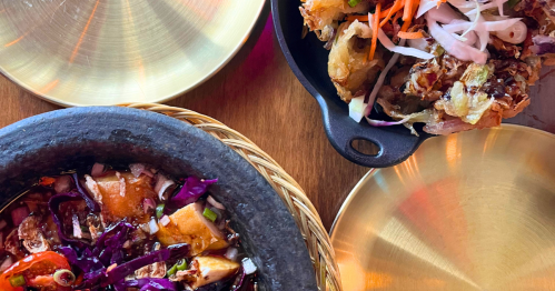 dishes of indonesian cuisine on a table at krakatoa in hollywood, florida