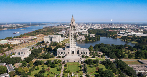 Louisiana State Capitol from above on a sunny day with much of Baton Rouge surrounding it