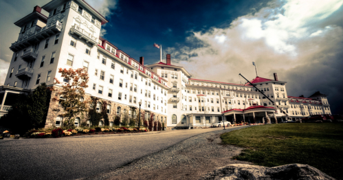 A nighttime view of the exterior of the Omni Mount Washington Resort in Bretton Woods, New Hampshire