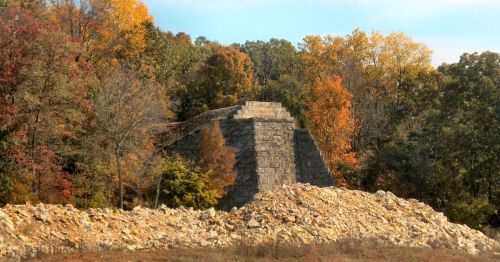 An old trestle foundation with a forest in the background.
