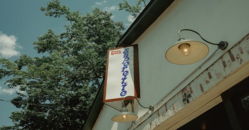Exterior photo of Pure Quill Superette's sign.