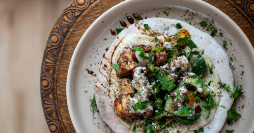 A close-up of a plate filled with Middle Eastern food.
