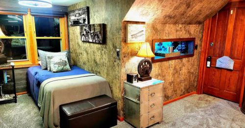 A single bed in a room with slanted walls.