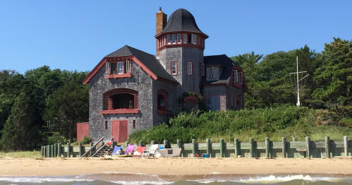 A close up exterior view of The Beach Castle VRBO waterfront rental property in Wellfleet, Massachusetts.