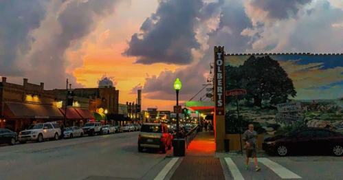 Downtown Grapevine, Texas at sunset with Tolbert’s Restaurant sign glowing along historic Main Street.