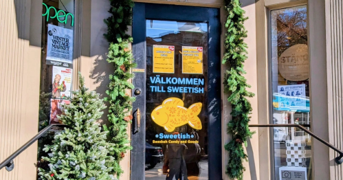 A store doorway with a yellow fish on it, reading "Sweetish Candy - A Swedish Candy Store"