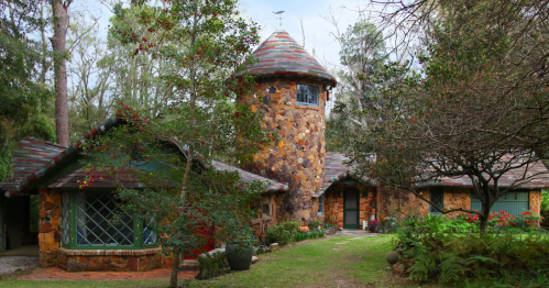 A whimsical castle Airbnb in Alabama with a lush lawn.