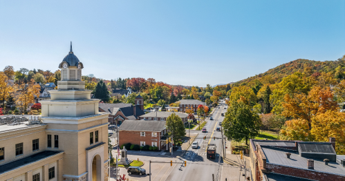A charming mountain town with vibrant fall foliage everywhere.
