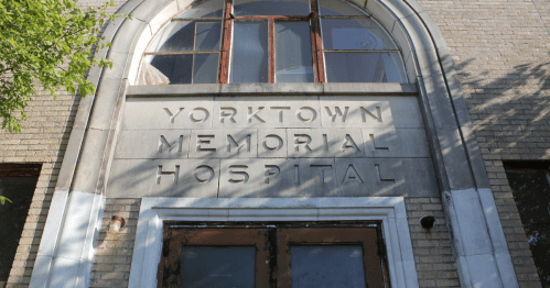 stone entryway of the yorktown memorial hospital, a creepy abandoned hospital in texas