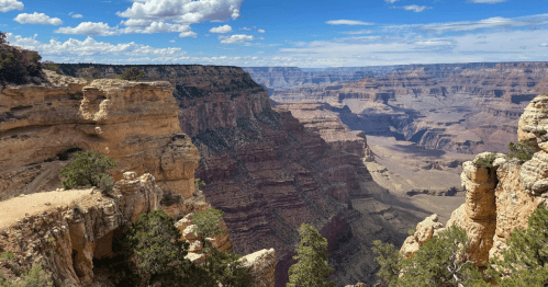 Grand Canyon view under a blue sky with yellows and reds in the rocks