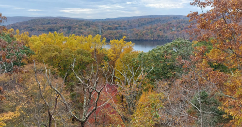 view of the river and hills of fall colors from an overlook at hurd state park in connecticut