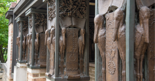 Carved wooden columns featuring birds in front of Frank Lloyd Wright's Oak Park studio