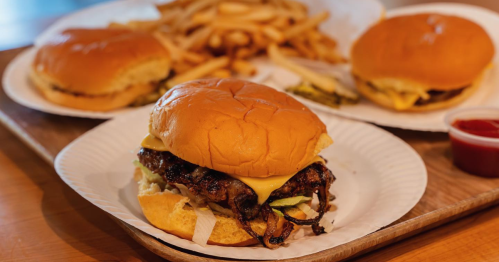 Some onion burgers with fries in the background from Sun Cattle Co. in OKC