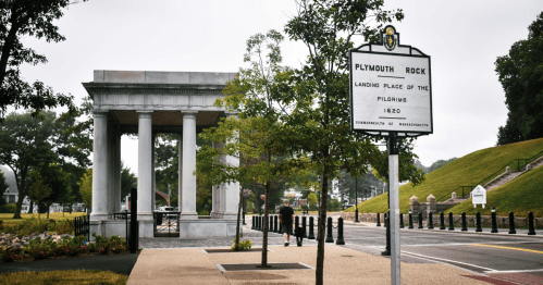 view of the interpretive sign and monment surrounding plymouth rock along a street in downtown plymouth, massachusetts