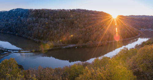 Stunning Gauley River gorge at sunset in late autumn with the sun dipping below the ridge.