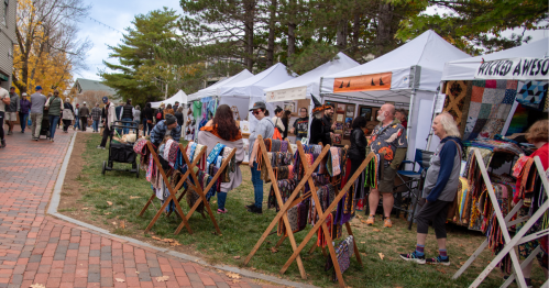 Vendor booths near the sidewalk at the Freeport Fall Festival in Maine.
