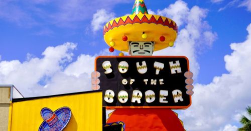 Large neon welcome sign for South of the Border, a popular roadside attraction in South Carolina