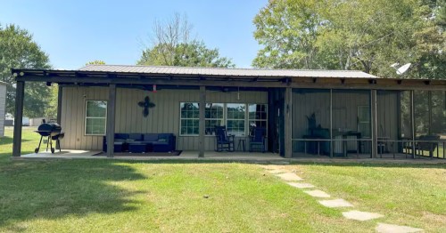 Exterior of the rear of the house at the Tight Lines Lodge vacation rental in Sabine Parish, Louisiana