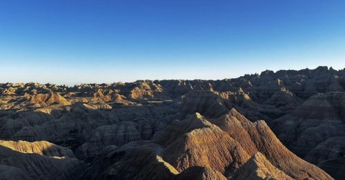 An overlook of a rocky canyon at sunset.
