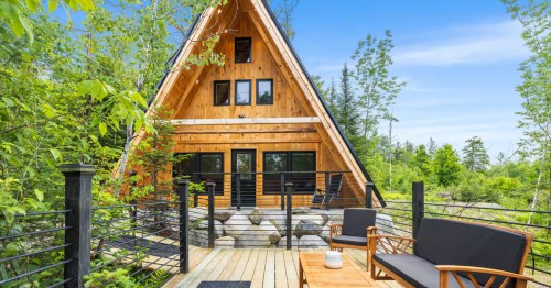 The Hideaway, a newly built wood A-frame with a spacious deck, ideal for families near Sugarloaf skiing.