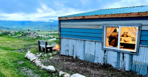 The exterior of a small Airbnb surrounded by open farm land near Livingston, Montana.