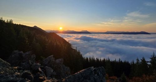 A fiery sunset above clouds as seen from the summit of Mount Si in Washington State.
