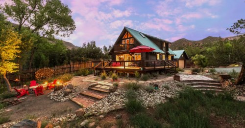 Exterior of River Oasis Airbnb in Jemez Springs, NM at dusk with purple clouds and blue skies in the background.