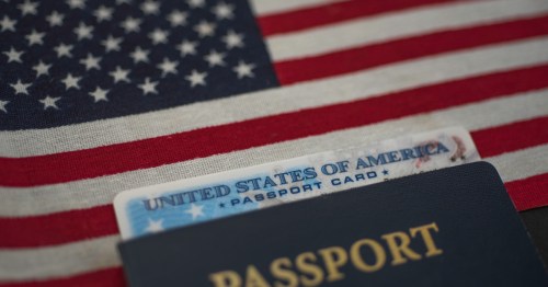 Passport card of USA covered by International American classic Passport on US Flag