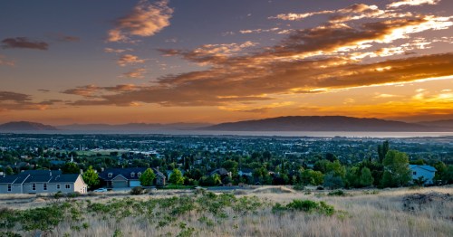 A fiery sunset falls over Saratoga Springs and Utah Lake.
