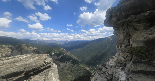 Looking over mountains, valleys, and vast skies at Storm Castle Peak in Montana.