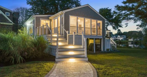 An exterior nighttime view of A Summer Place Airbnb rental in South Kingstown, Rhode Island.
