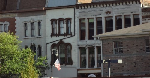 A closeup of storefront buildings in a small downtown area.